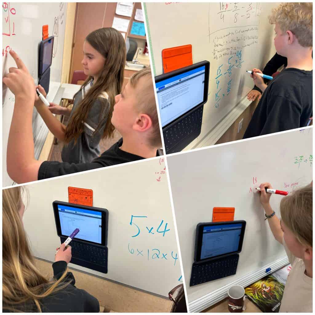 6th grade students in Mr. Stover's class work together as they solve word problems on the white board.