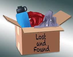 A cardboard box labeled "Lost and Found" containing various items like clothes and a water bottle.